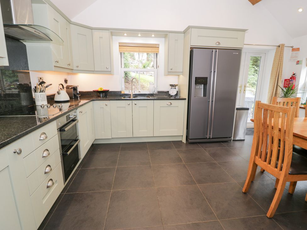 A kitchen with cabinets and appliances at Greffyn in Betws-Y-Coed