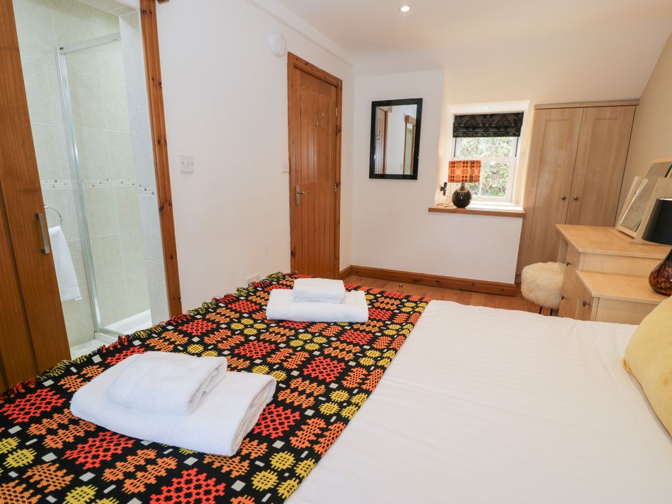 A bedroom with a bed and shower at Greffyn in Betws-Y-Coed