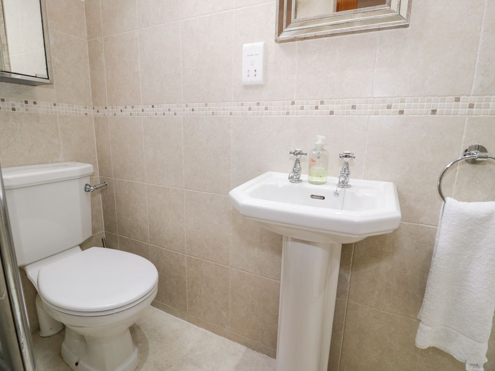 A bathroom with a toilet and sink at Greffyn in Betws-Y-Coed