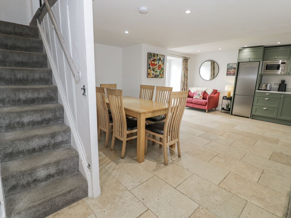 A dining room with a table and chairs at Orsedd Wen Farmhouse Betws-Y-Coed