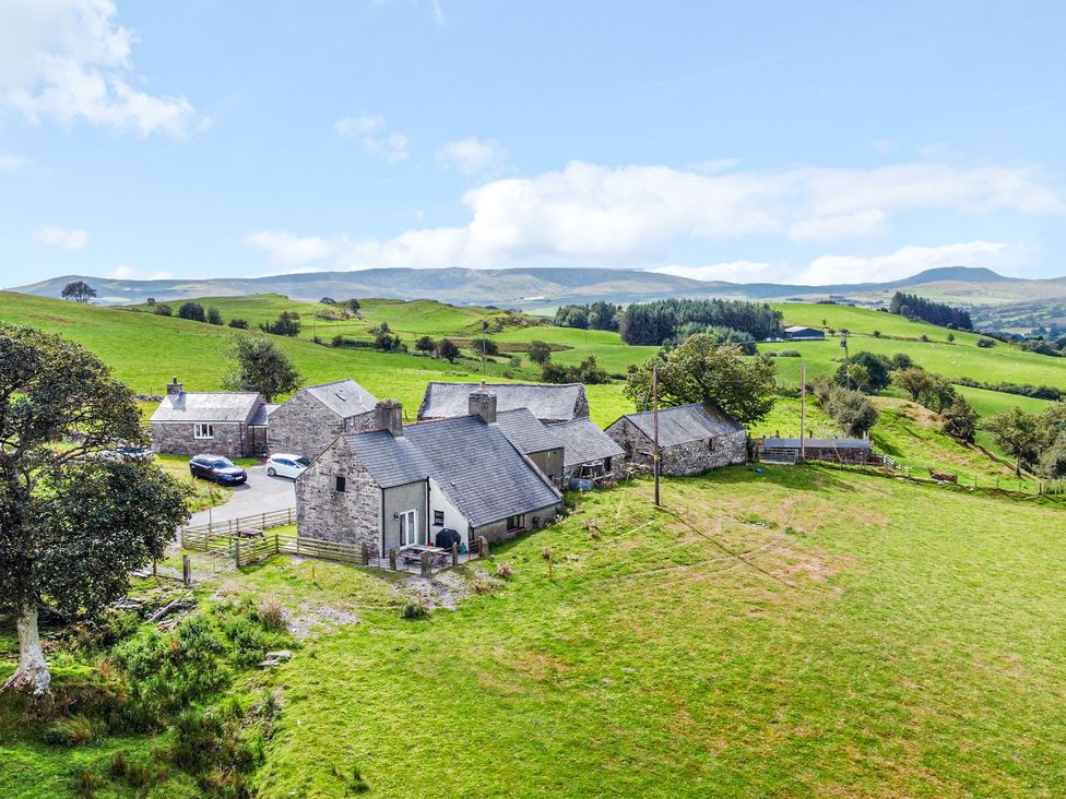 An outdoor view of a farmhouse with surrounding land at Orsedd Wen Farmhouse Betws-Y-Coed