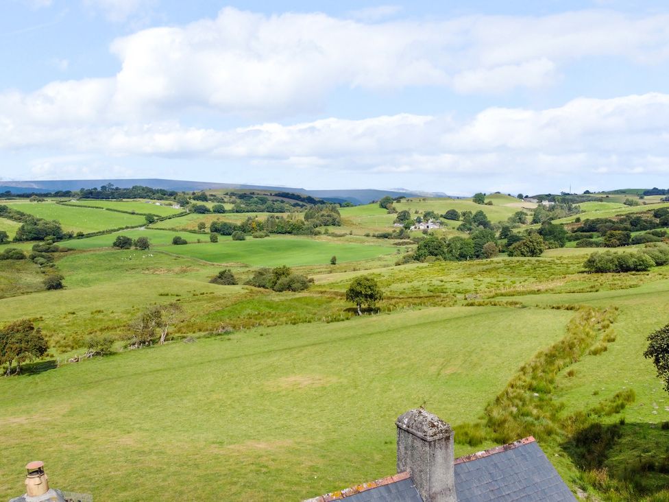 A landscape view with hills and trees at Orsedd Wen Farmhouse in Betws-Y-Coed