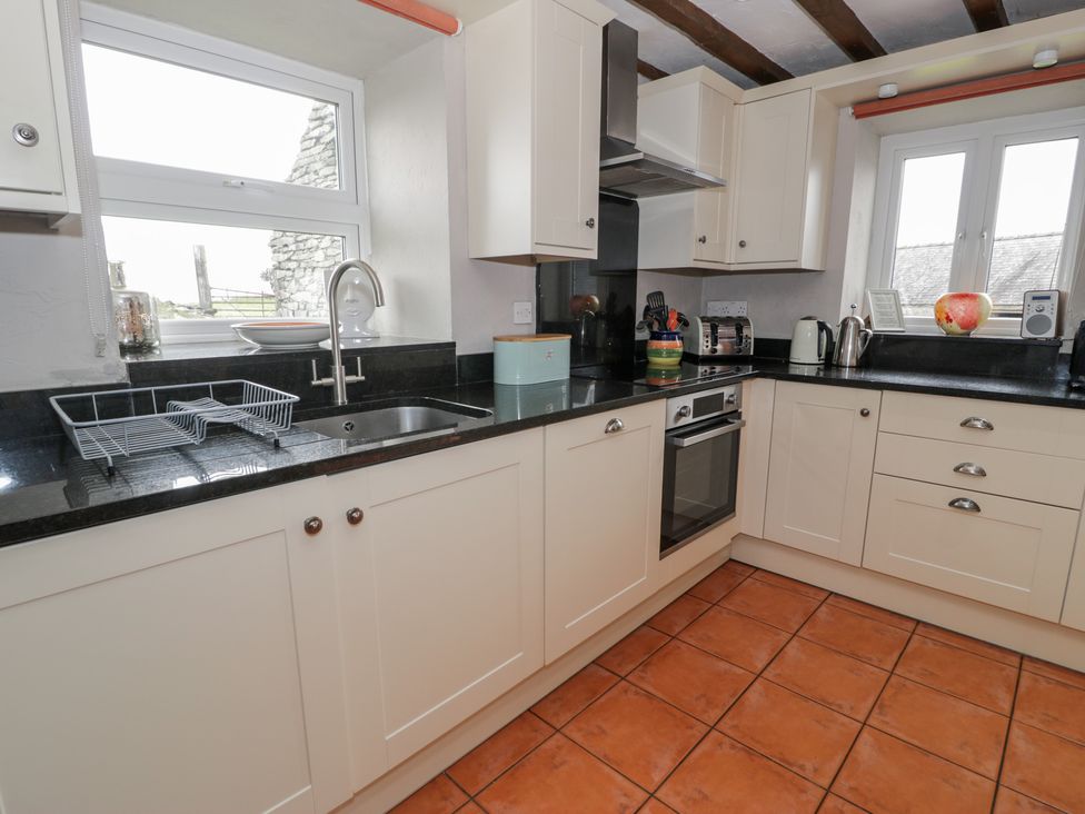 A kitchen with a sink and cabinets at Orsedd Wen Cottage in Betws-Y-Coed