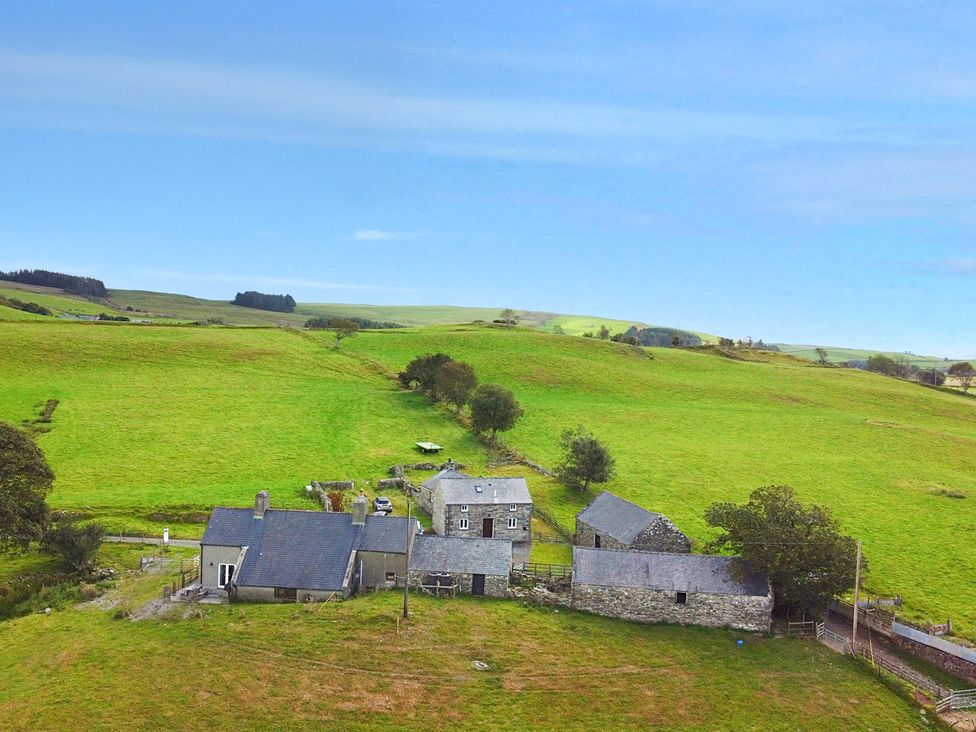 A view of several houses in a field at Orsedd Wen Cottage Betws-Y-Coed