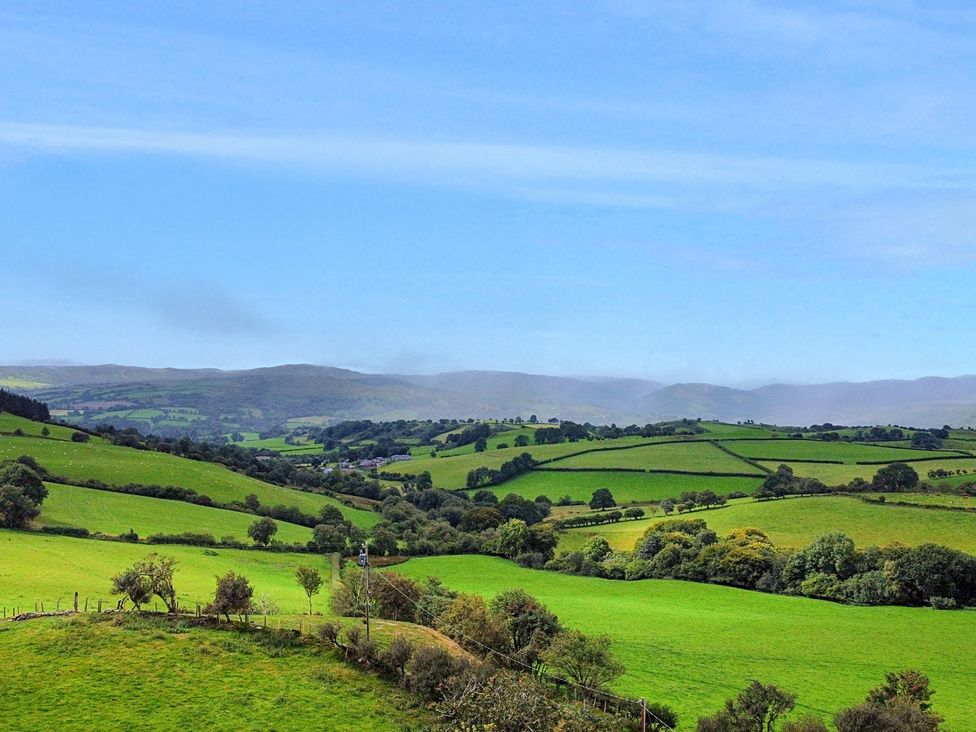 A landscape view of fields and hills at Orsedd Wen Cottage Betws-Y-Coed