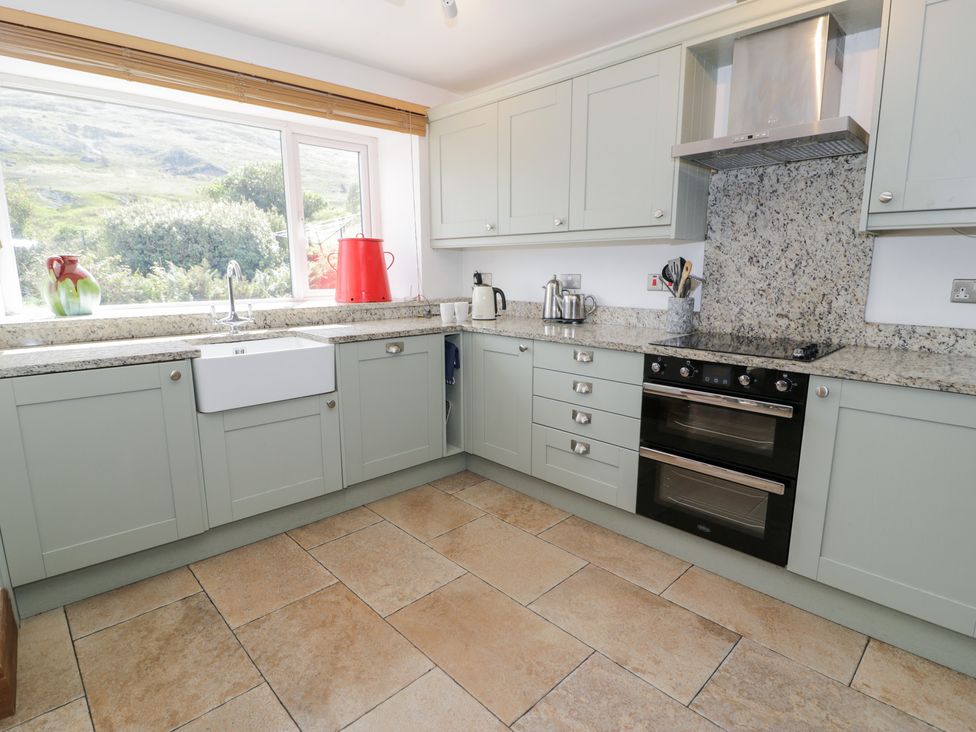 A kitchen with a sink and stove at Cwm in Capel Curig