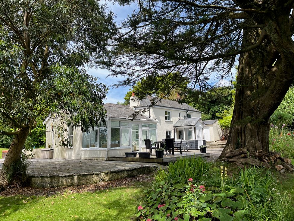 A house with a deck and garden at Otterburn House in Bude