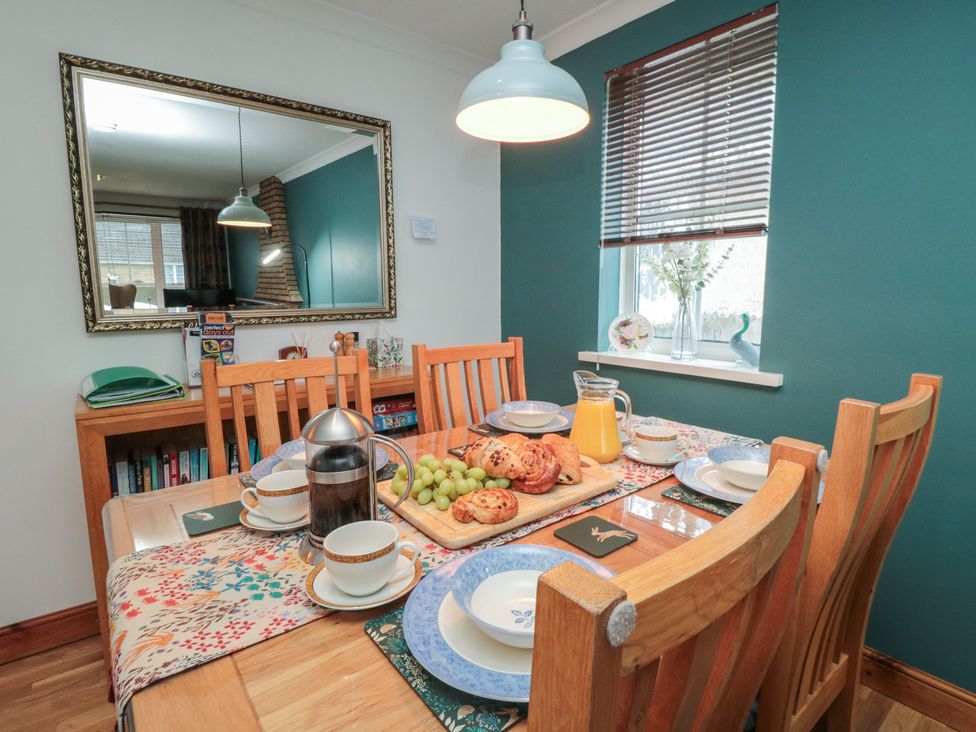 A dining room with a table set for breakfast at 17 Costa Way Pickering