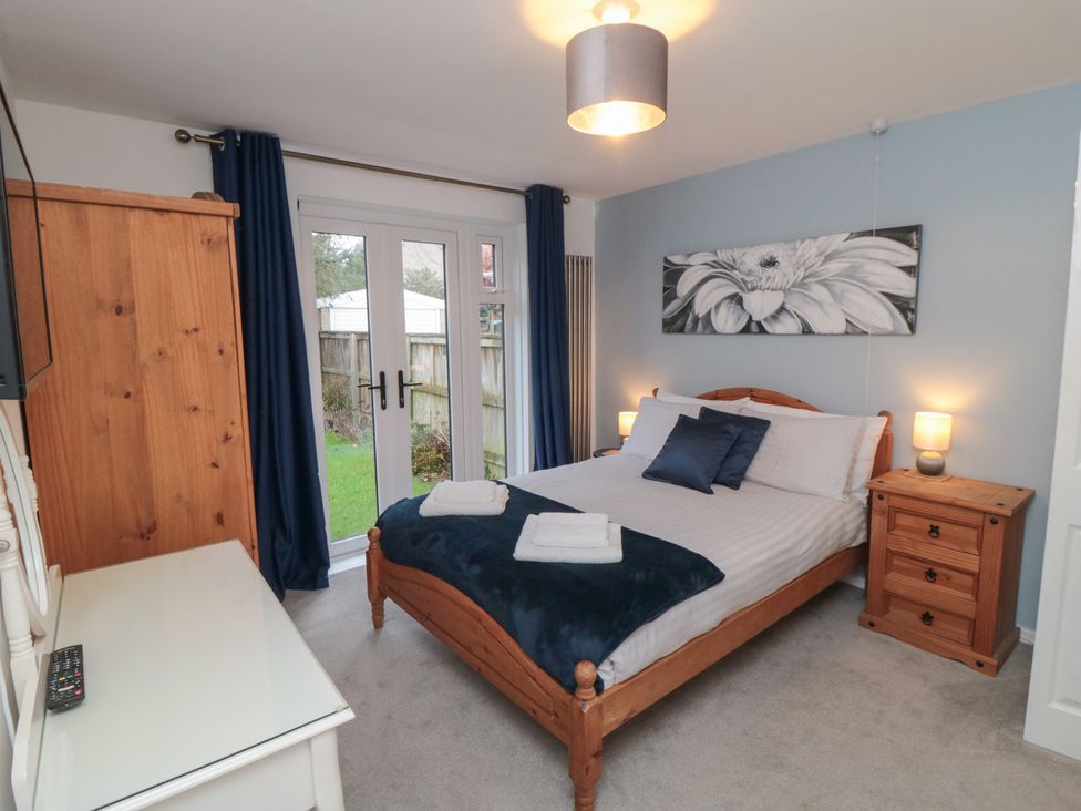 A bedroom with a bed and wardrobe at 17 Costa Way in Pickering