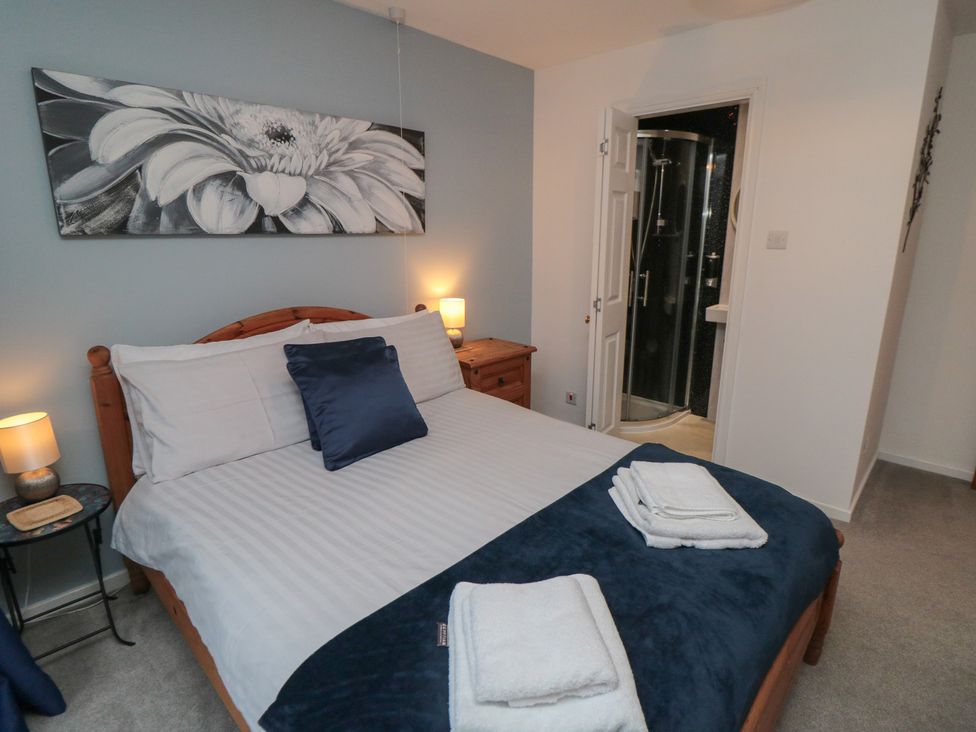 A bedroom with a bed and shower area at 17 Costa Way in Pickering