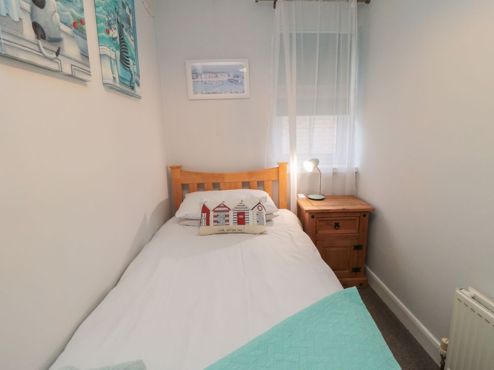 A bedroom with a single bed and nightstand at 17 Costa Way in Pickering