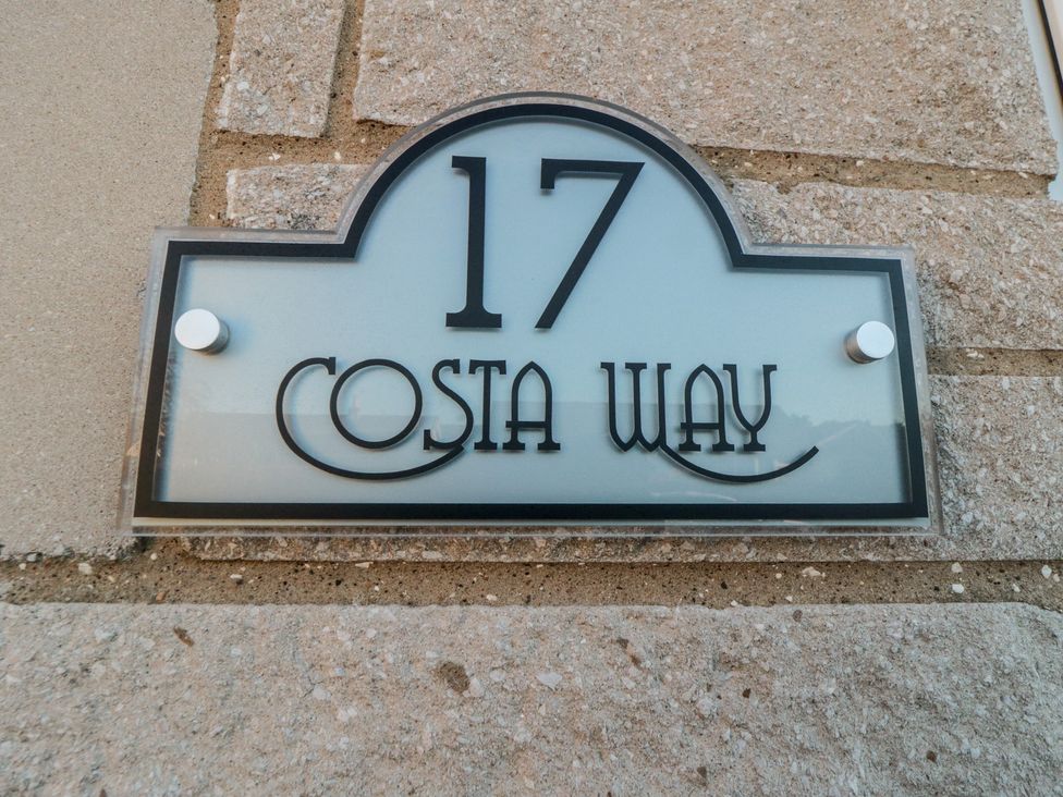 A sign displaying the address 17 Costa Way at 17 Costa Way in Pickering