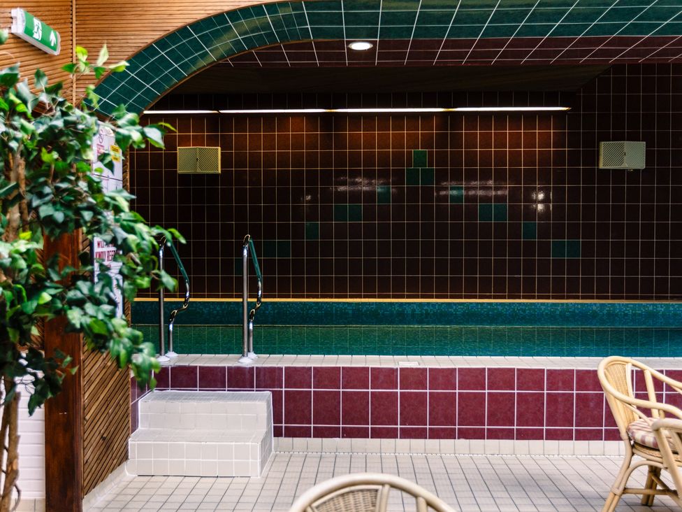 An indoor pool area with stairs and tiles at Rose Cottage in Akeld near Wooler