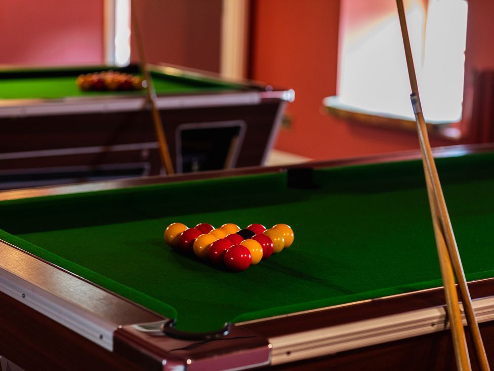 A pool table with balls set up for a game at Manor Cottage in Wooler