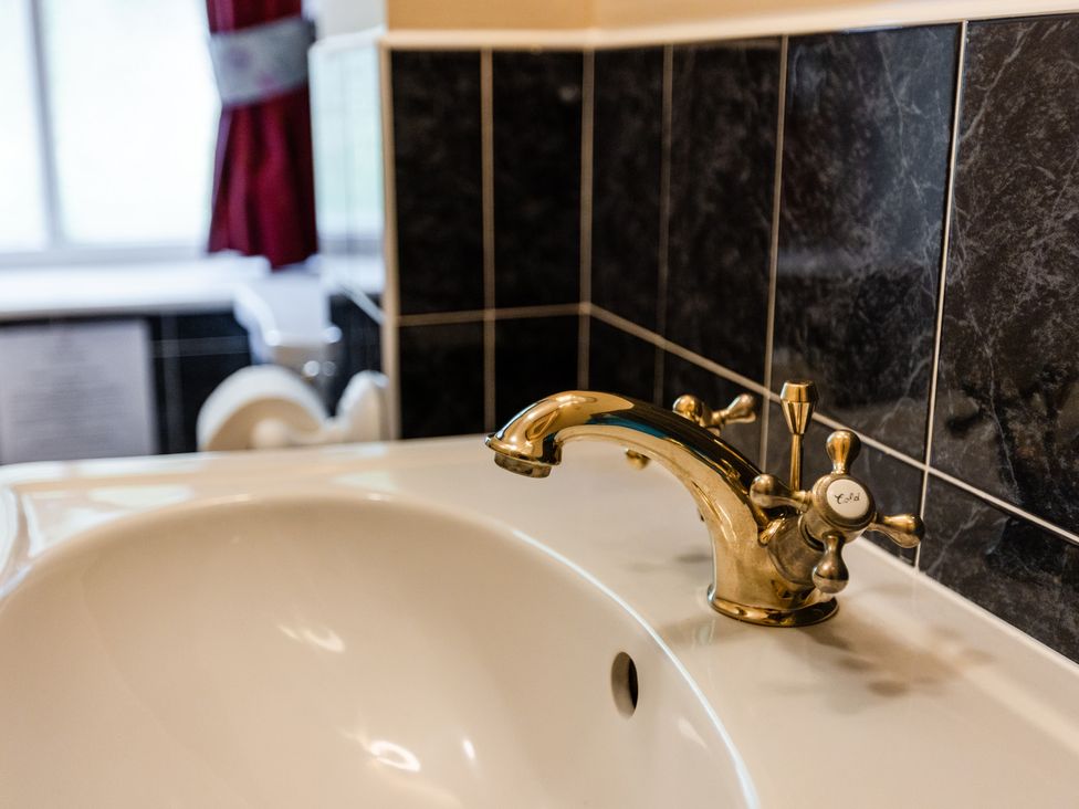 A bathroom sink with a faucet at Fern Cottage in Akeld near Wooler