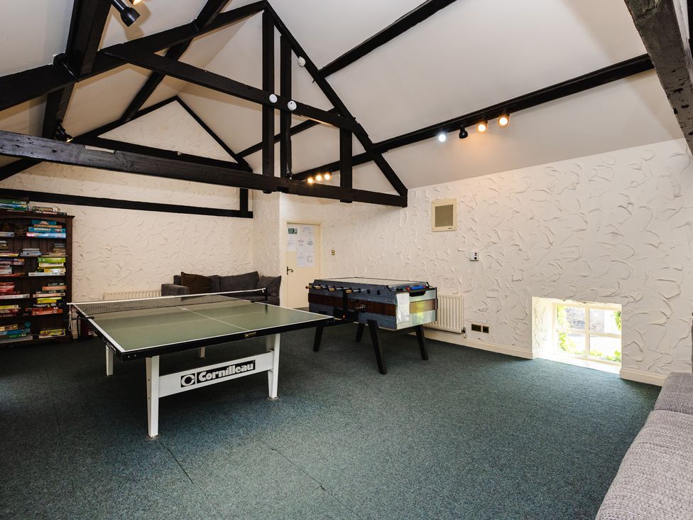 A games room with a ping pong table and foosball table at Lupin Cottage in Akeld near Wooler