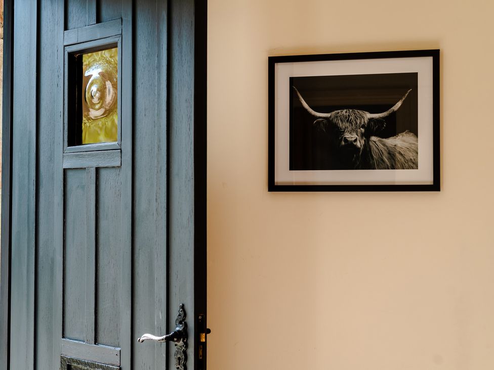 An entrance with a door and a framed picture at Bramble Cottage in Akeld near Wooler