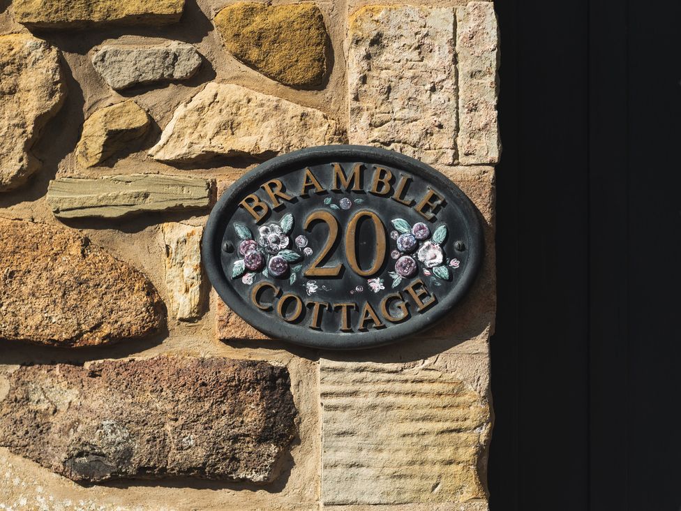 A house sign displaying Bramble Cottage 20 in Akeld near Wooler