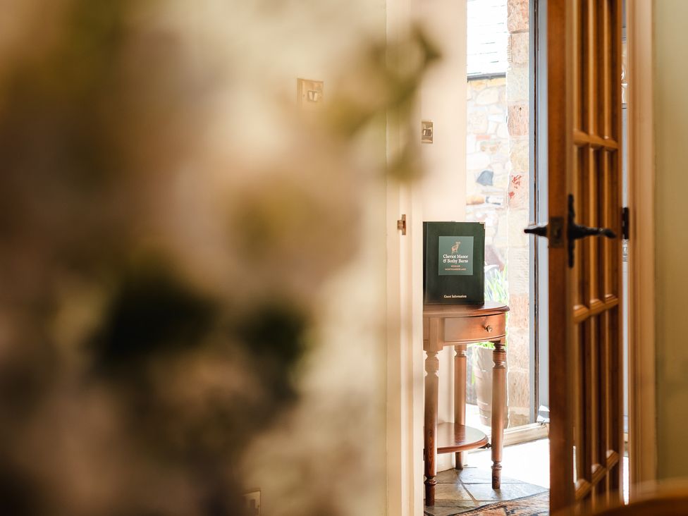 An entrance with a table and information booklet at Bramble Cottage near Wooler
