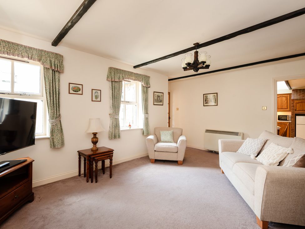 A living room with a television and seating at Bramble Cottage Akeld near Wooler
