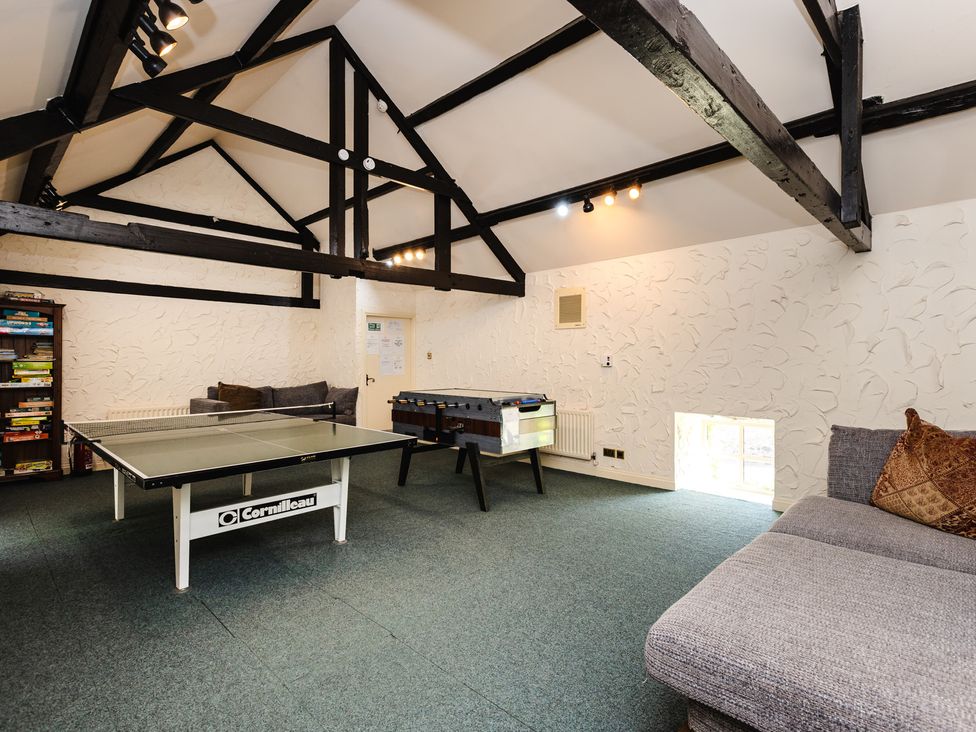 A recreation room with a ping pong table and foosball table at Tile Rouge in Wooler