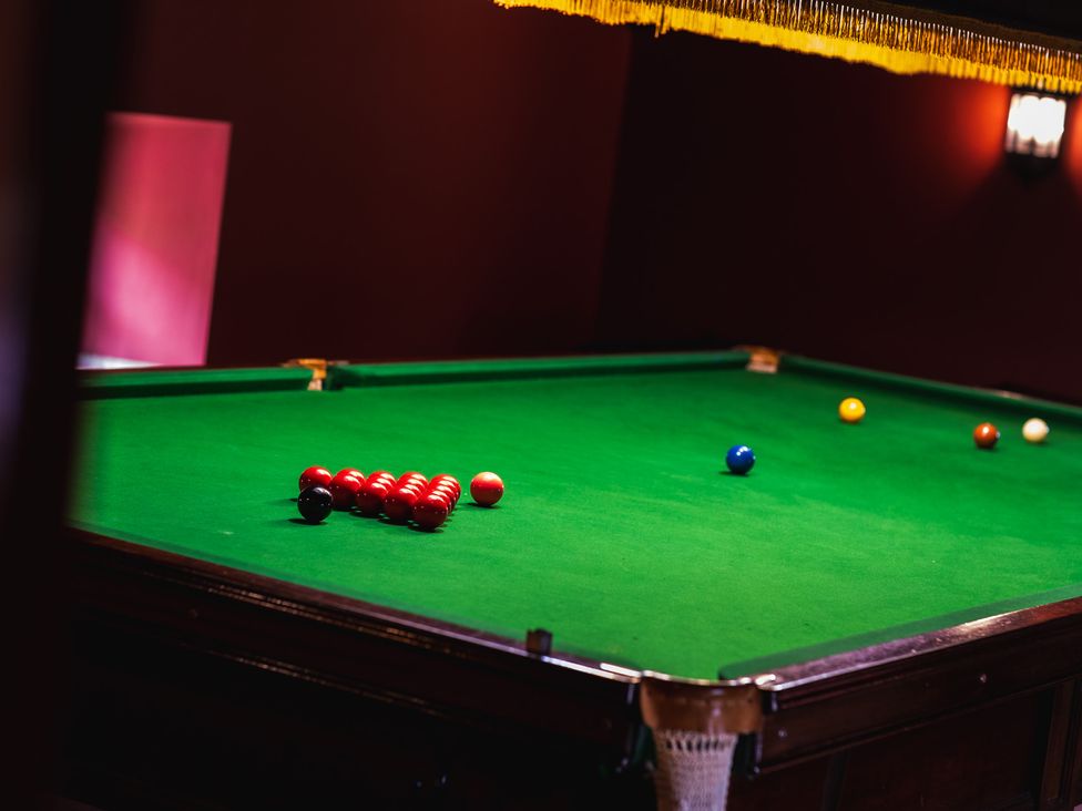 A snooker table with balls arranged at Tile Rouge in Wooler