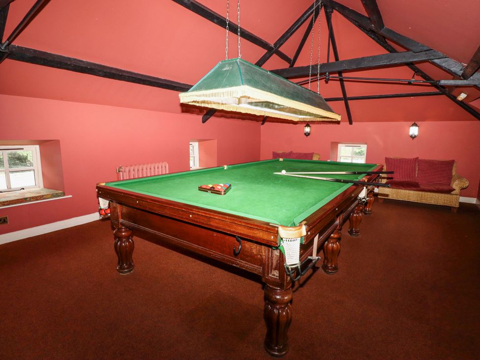 A recreation room with a pool table and seating area at Hollyhock in Akeld near Wooler