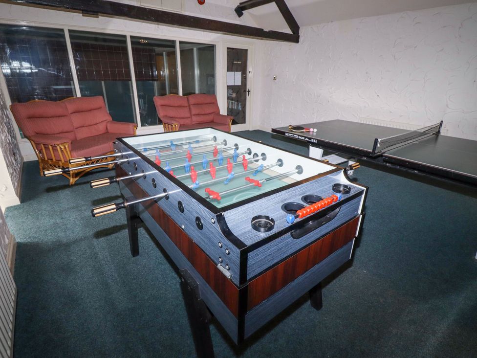 A recreation room with a foosball table and table tennis table at Hollyhock in Akeld near Wooler