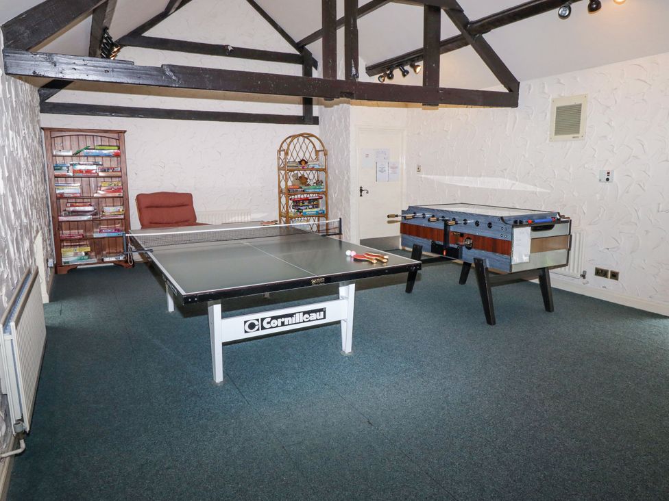 A games room with table tennis and foosball tables at Hollyhock in Akeld near Wooler