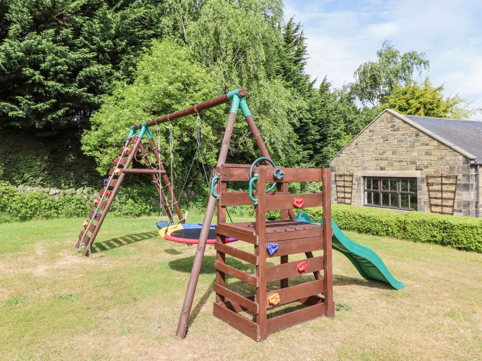 A playground with swing set and slide at Hollyhock in Akeld near Wooler