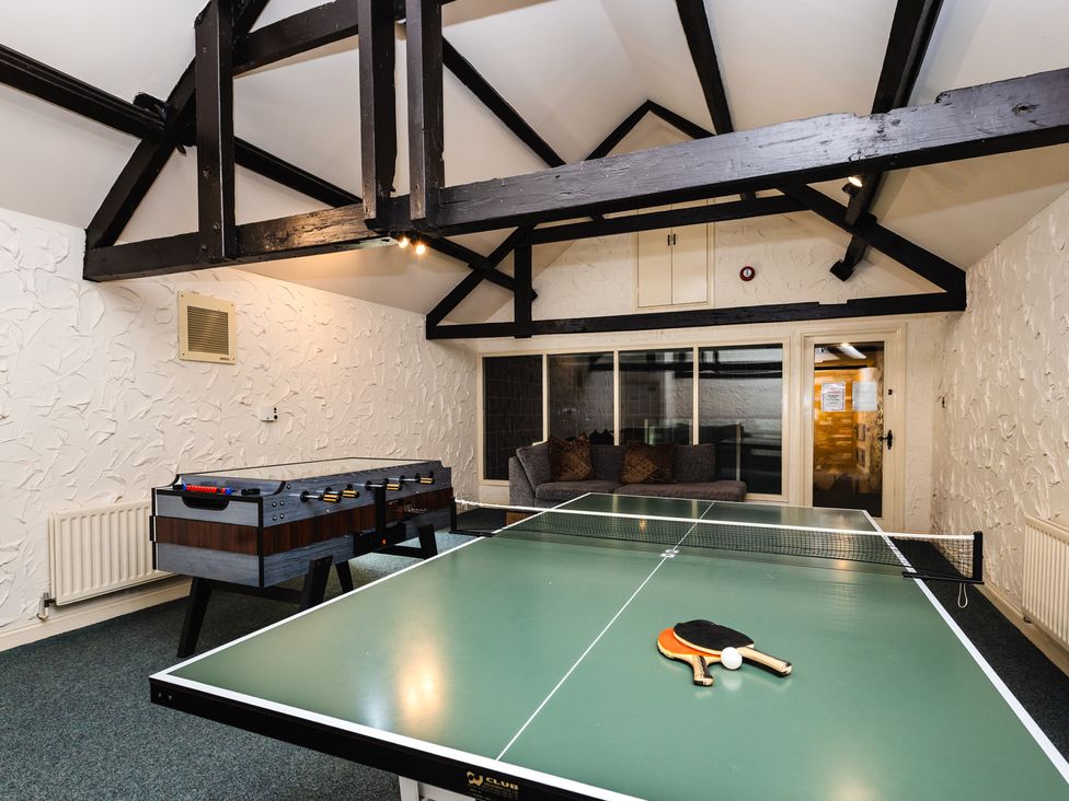 A games room with a table tennis table and foosball table at Heatherview in Wooler