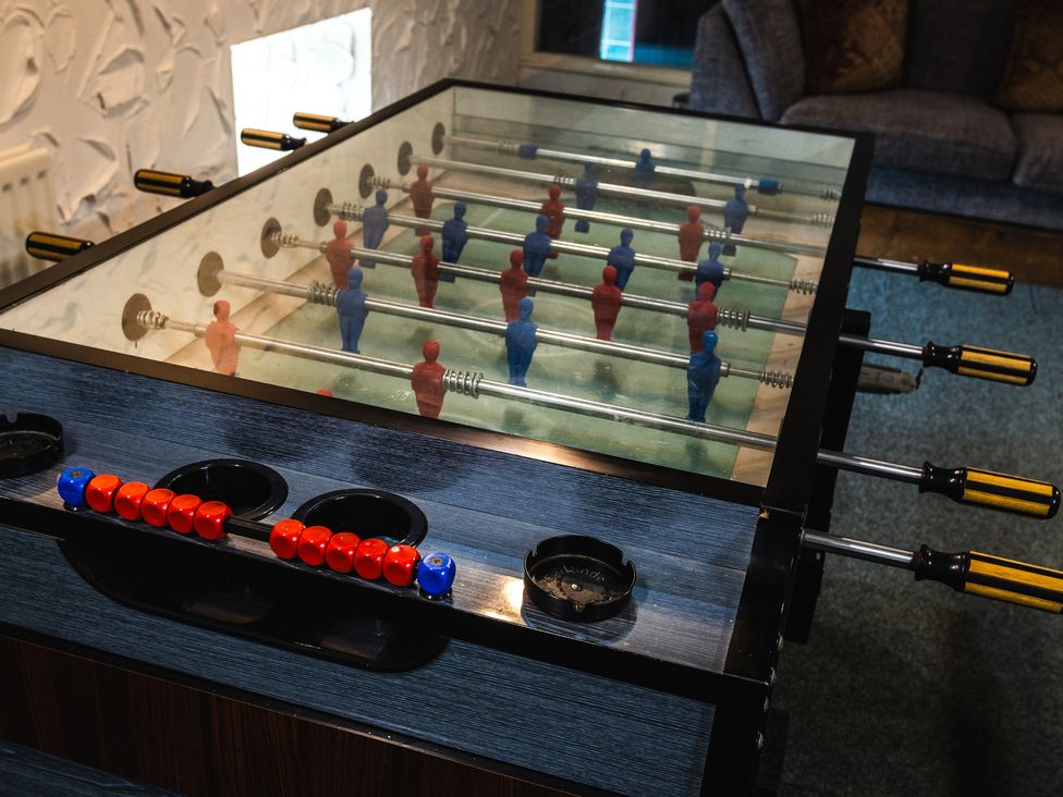 A foosball table with red and blue players in a recreation room at Heatherview Wooler