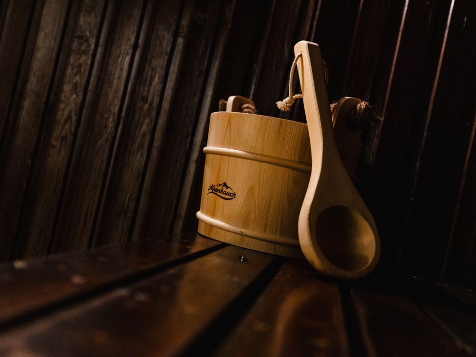 A wooden bucket and ladle in a sauna at The Columbine in Akeld near Wooler