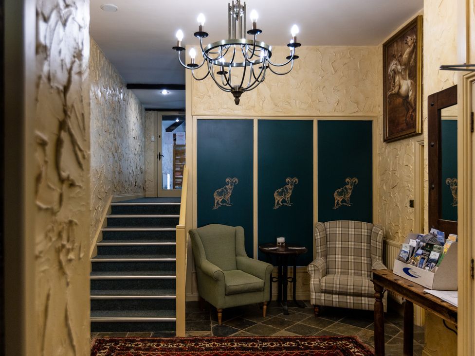 A hallway with two chairs and a staircase at The Columbine in Akeld near Wooler