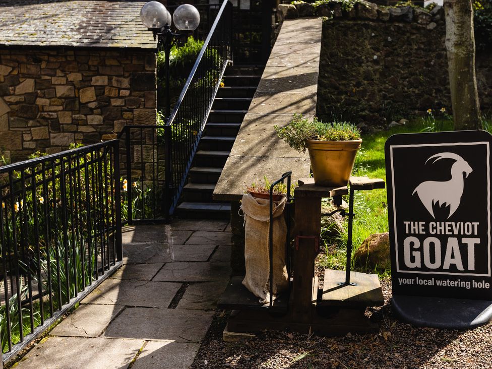 An outdoor area featuring stairs and a sign at The Cheviot Goat in Akeld near Wooler