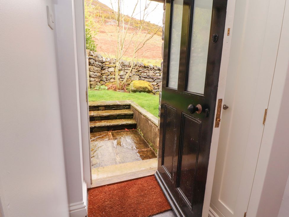 An entrance with an open door leading to steps and a garden at Two Town End in Mungrisdale, Mosedale