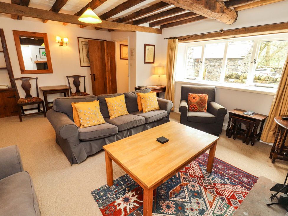 A living room with a sofa and a coffee table at Two Town End in Mungrisdale, Mosedale