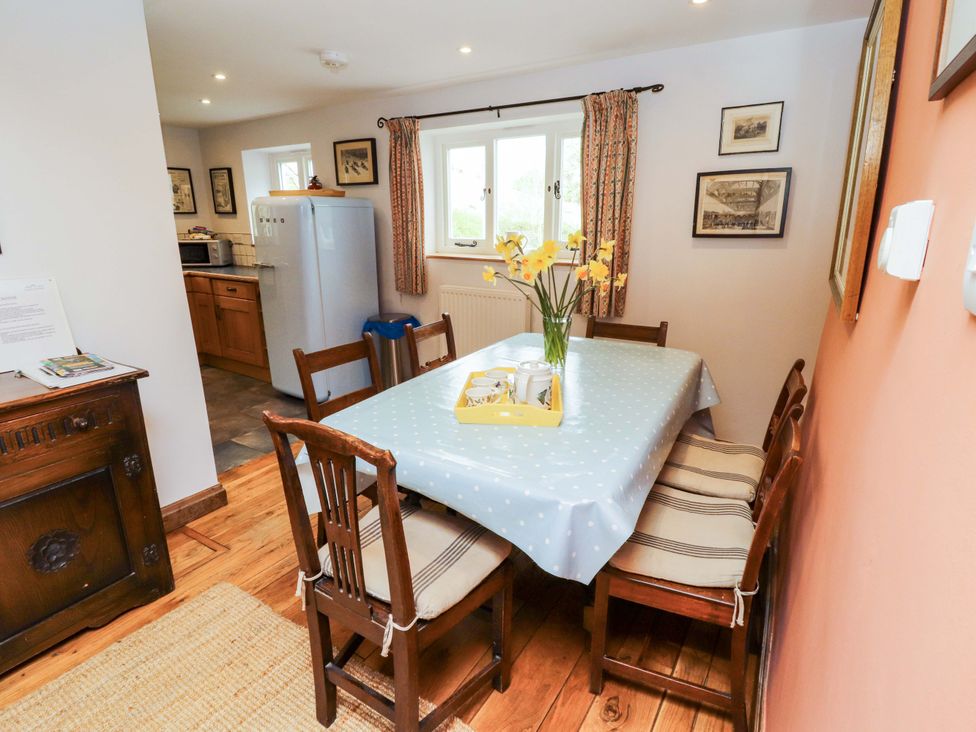 A dining room with a table and chairs at Two Town End in Mungrisdale, Mosedale