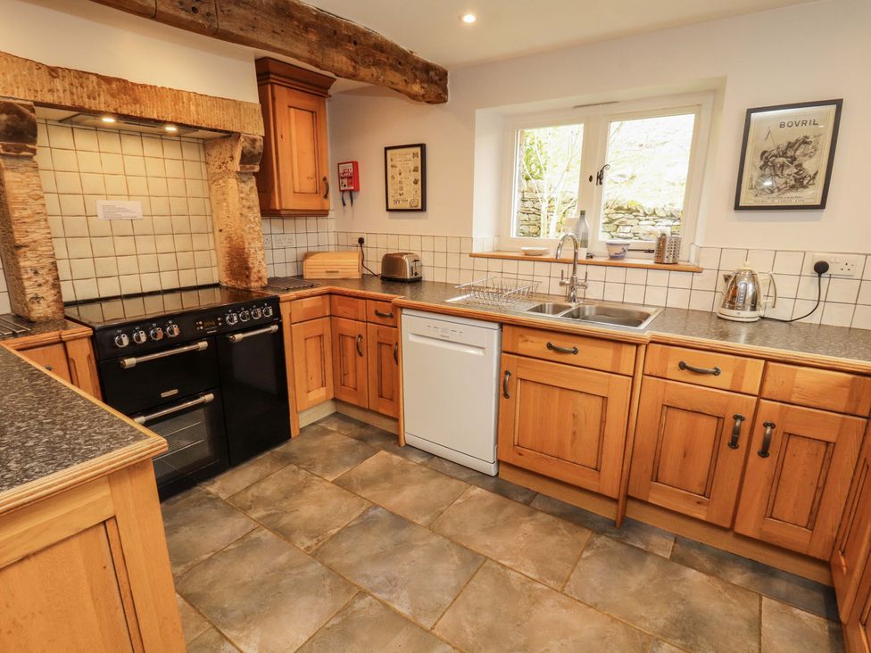 A kitchen with cabinets and appliances at Two Town End Mungrisdale, Mosedale