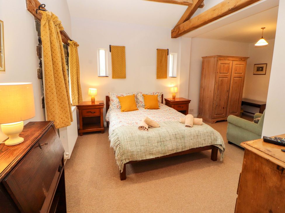 A bedroom with a bed and wardrobe at Two Town End, Mungrisdale, Mosedale