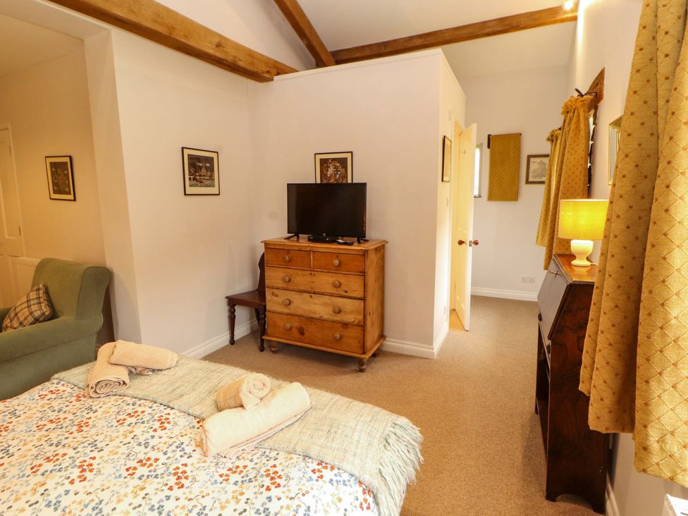A bedroom with a bed and a television at Two Town End in Mungrisdale, Mosedale