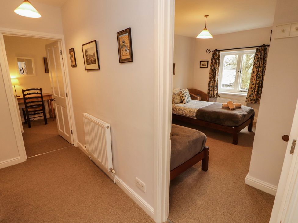 A bedroom with two beds and a window at Two Town End in Mungrisdale, Mosedale