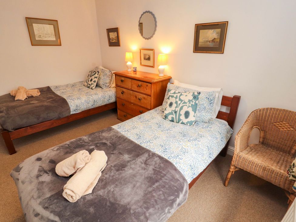 A bedroom with two beds and a chest of drawers at Two Town End in Mungrisdale, Mosedale