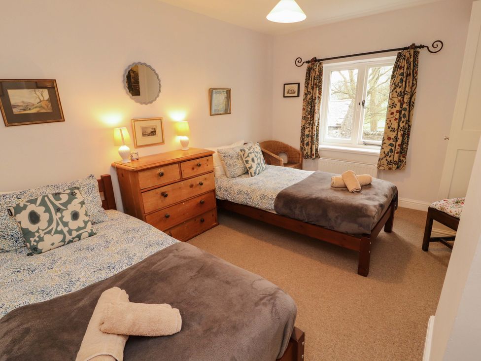 A bedroom with two beds and a dresser at Two Town End in Mungrisdale, Mosedale