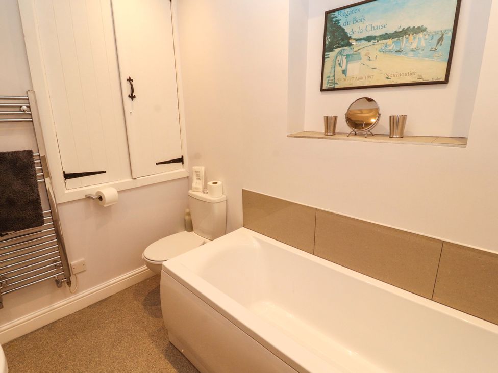 A bathroom with a bathtub and toilet at Two Town End in Mungrisdale, Mosedale