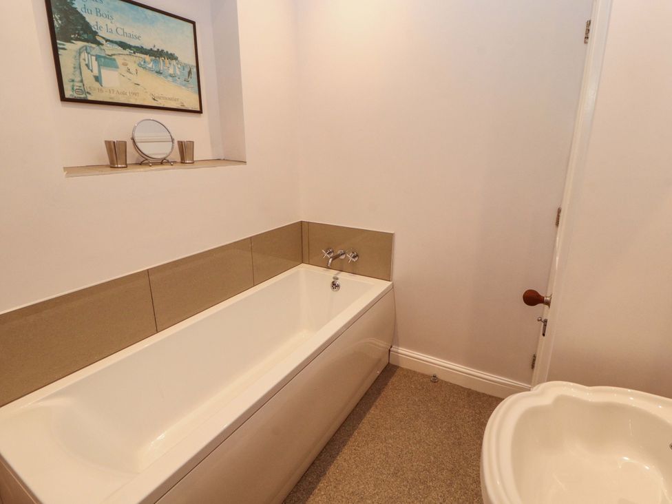 A bathroom with a bath tub and toilet at Two Town End, Mungrisdale, Mosedale