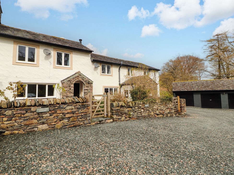A house with a stone wall and garage at Two Town End, Mungrisdale, Mosedale