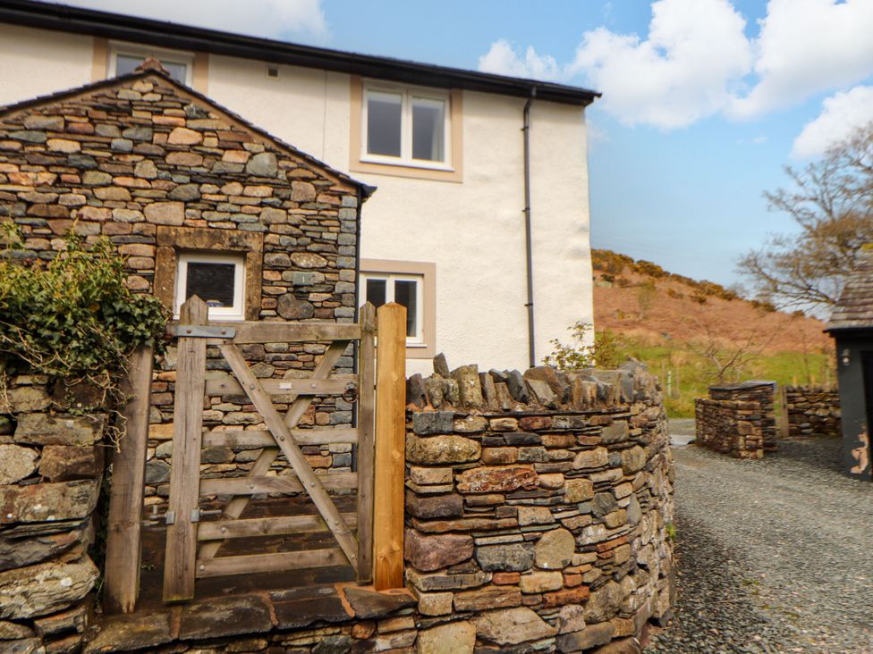 A gate next to a stone wall leading to a house at Two Town End Mungrisdale, Mosedale
