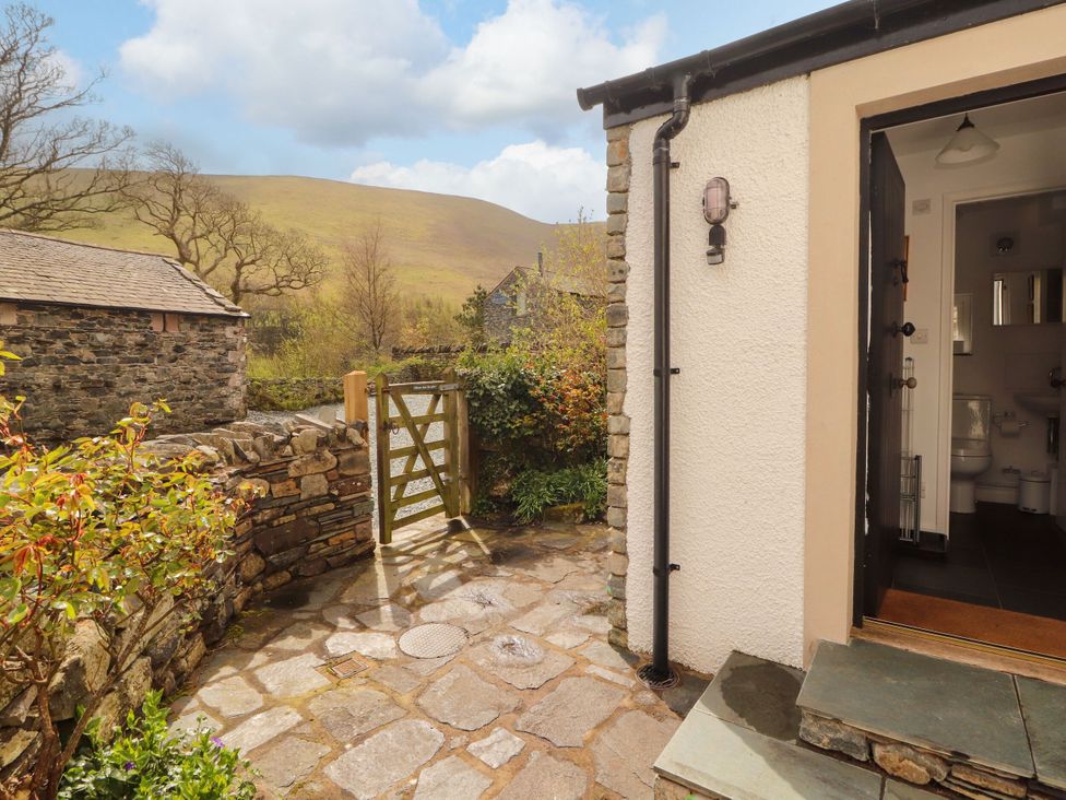 An outdoor area with a stone path and a gate at Two Town End Mungrisdale, Mosedale