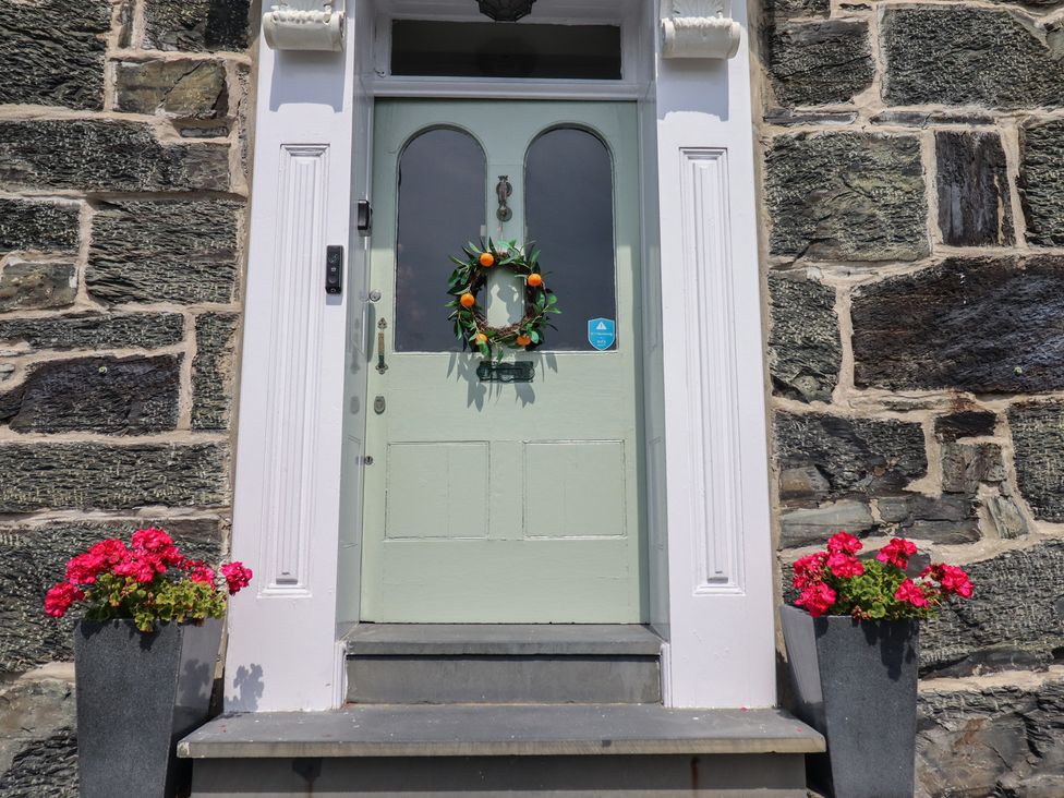 An entrance with a door and flower planters at 5 Porkington Terrace Barmouth